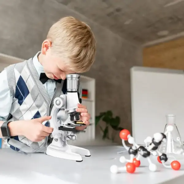 Beginner microscope kit for kids - 100X-1200X magnification with LED light for science experiments.